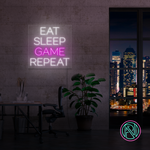 LED neonskilt i rosa med teksten «EAT SLEEP GAME REPEAT»