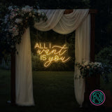 LED-neonskilt med tekst “ALL I want IS you” i gyllent gult lys.