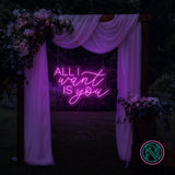 LED-neonskilt med tekst “ALL I want IS you” i magentarosa lys.