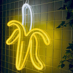 LED-neonskilt i bananform i sitrongult og hvitt lys.