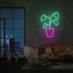 LED-neonskilt i monsteraform med hjerteblad, grønn og rosa neonlys.